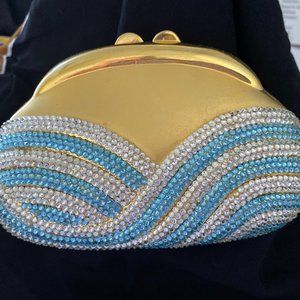 Hand designed with Swarovski crystals, hard sided evening clutch.